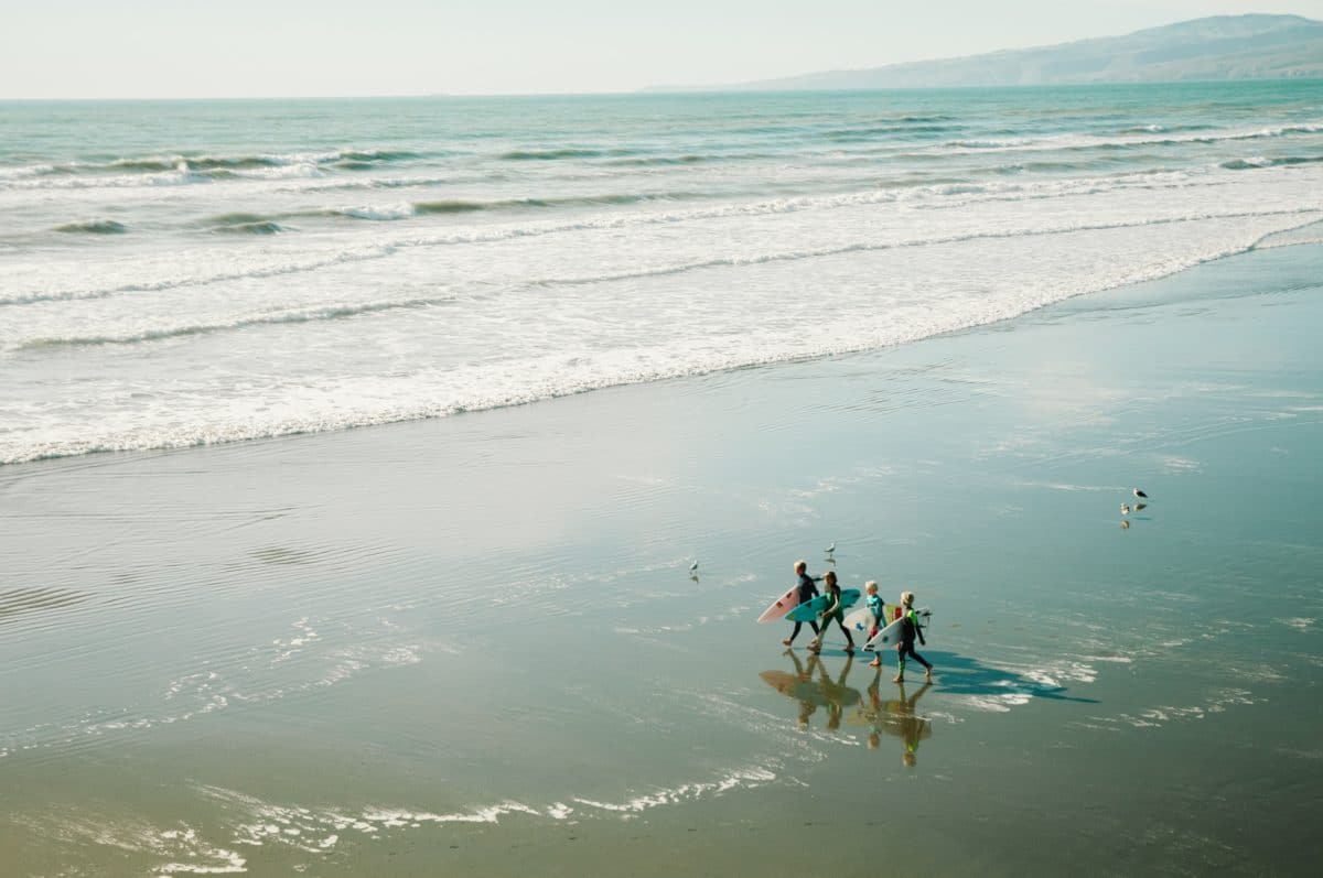 kids surfing on beach